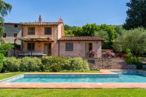 a house with a swimming pool in front of a house at Bertolli Villas in Matraia