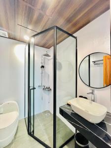 a bathroom with a sink and a mirror at BRIO Urbano Apartment in Da Nang +100 photos