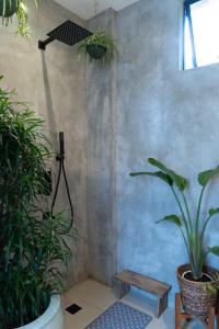 a room with two potted plants and a wooden table at The Getaway Bailen in General Emilio Aguinaldo