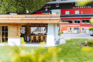a log cabin with a patio in front of a building at Hotel Alpenroyal - The Leading Hotels of the World in Selva di Val Gardena +55 photos