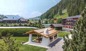 a resort in the mountains with a building at Hotel Alpenroyal - The Leading Hotels of the World in Selva di Val Gardena