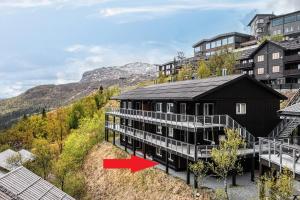 an aerial view of a building with a red arrow at Large Ski in-Ski out Apartment for Groups in Hemsedal