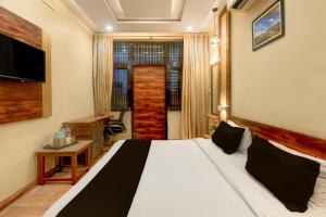 a bedroom with a large white bed in a room at Townhouse Punnami Riverview Formerly Vihaan Square in Jaipur