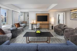 a living room with a couch and a tv at Hilton Milwaukee in Milwaukee