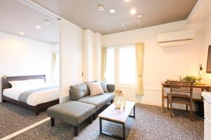 Ένα ή περισσότερα κρεβάτια σε δωμάτιο στο Hotel Stripe 札幌