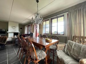 a dining room with a table and a couch at Nice And Central With Terrace in Beitostøl