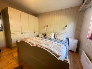 a bedroom with a bed and a wooden floor at Nice And Central With Terrace in Beitostøl