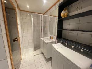 a bathroom with a shower and a sink and a toilet at Nice And Central With Terrace in Beitostøl +41 photos