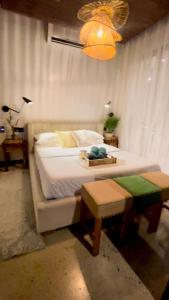 a bedroom with a large bed and a chandelier at The Getaway Bailen in General Emilio Aguinaldo