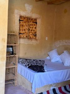 a small bed in a room with a window at The Green Siwa Hotel in Siwa +16 photos