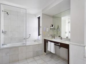 a bathroom with a tub and a sink and a shower at Mercure Sao Paulo Grand Plaza Paulista in Sao Paulo
