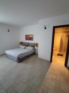 a large bedroom with a bed and a doorway at Case vacanza "LA FORNACE" in Vagliagli +37 photos