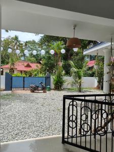 a gate with a motorcycle parked in a yard at Shamak Homestay Varkala in Varkala