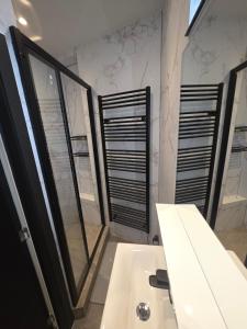 a bathroom with a sink and a large mirror at First in Tournai
