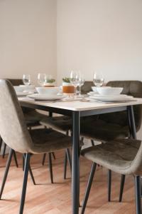 a table with wine glasses and plates on it at Beechgrove House in Livingston