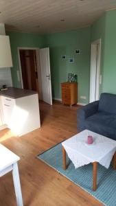 a living room with a couch and a table at Ferienwohnung Wiesenblick in Gödenstorf +1 photo