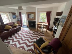 a living room with a couch and a table at Robinsons Cottage, central and quiet in Cockermouth