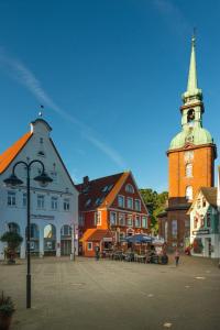 a town with a clock tower and a building at Moby Dick in Olpenitzdorf
