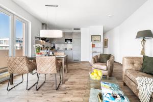 a living room with a couch and a table and chairs at Admirals Cabin in Olpenitzdorf