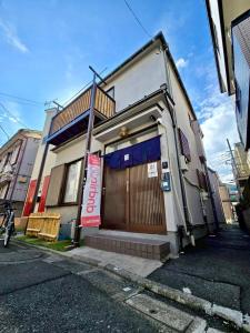 a building with a sign on the side of it at Mic HANEDA in Tokyo
