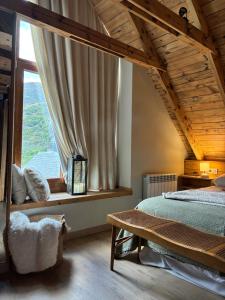 a bedroom with a bed and a large window at Eth Estel de Salardú--Casa con vistas de ensueño-Fibra Optica,5TV in Salardú