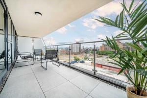 an apartment balcony with a view of the city at Luxury 2BR Penthouse-1, Private Terrace, City Center, Free Parking in Leeds +44 photos