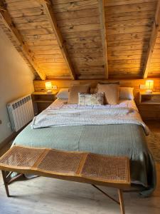 a bedroom with a large bed with wooden ceilings at Eth Estel de Salardú--Casa con vistas de ensueño-Fibra Optica,5TV in Salardú
