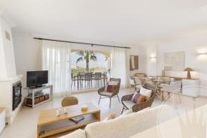 ein Wohnzimmer mit Couch und ein Esszimmer in der Unterkunft La Manga Club Resort - Los Olivos 130 in Atamaría