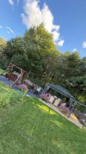 a garden with benches and flowers in the grass at Chill House Wierzchucinek in Wierzchucinek