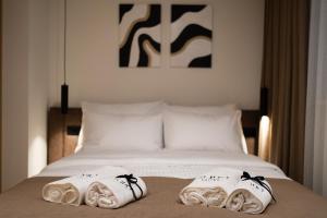 a bedroom with a bed with two towels on it at Soho Suites Skopje City Centre - Luxury Apartments in Skopje