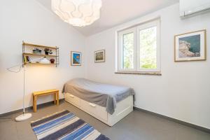 una camera da letto con un letto e una finestra di Holiday house VILLA ANTON with private pool a Kras Altre 27 foto