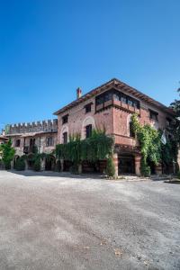 a large brick building with plants on it at La Locanda di Grazzano Visconti in Grazzano Visconti