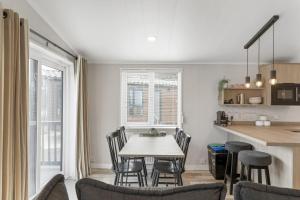 a kitchen and dining room with a table and chairs at Modern Lodge nr Ilfracombe & Beaches in West Down