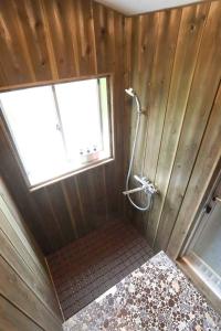 a bathroom with a shower in a wooden wall at ひだまりの宿 まゆしょう in Omachi +26 photos