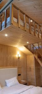 a bed in a room with a wooden ceiling at Harshvan resort in Chakrāta
