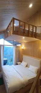 a bedroom with two bunk beds in a cabin at Harshvan resort in Chakrāta +10 photos