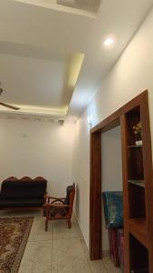 a living room with a couch and a chair at Dolmens castle in Marayoor