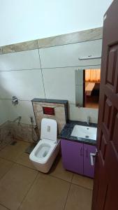 a bathroom with a toilet and a sink at Dolmens castle in Marayoor +14 photos