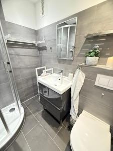 a bathroom with a sink and a toilet at Wohnung Bernstein in Burgtiefe auf Fehmarn 
