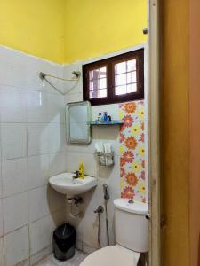 a bathroom with a toilet and a sink at Honza Hostel in Cochin