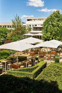 a group of white umbrellas in front of a building at The Westin Grand Berlin in Berlin