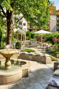 a fountain in a courtyard with tables and chairs at The Westin Grand Berlin in Berlin