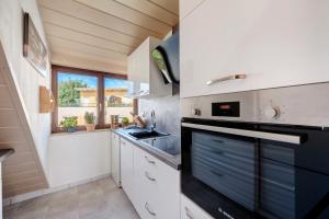a kitchen with a sink and a stove at Großzügige Maisonettewohnung in Sindelfingen +17 photos