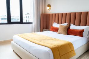 a bedroom with a large bed with orange pillows at hôtel LE PACHA in Tunis