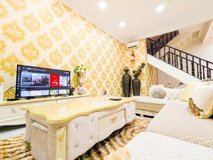 バタム・センターにあるLovina C3 no 8 at Tropicana Residenceのソファとテレビのあるリビングルーム