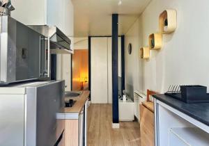 a kitchen with a sink and a counter top at Le Beige in Le Mans