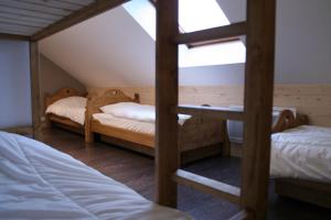 a attic room with two bunk beds and a ladder at Chalet camp de base pour tribu sportif wifi 5 ch in Le Lioran