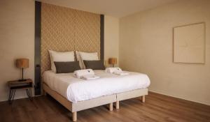a bedroom with a bed with two towels on it at Villa La Perle in Talmont +5 photos