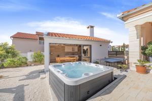 a hot tub in the backyard of a house at Villa Kunfin ZadarVillas in Bibinje