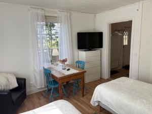 a room with a table and chairs and a bed at Sveabo in Kumla
